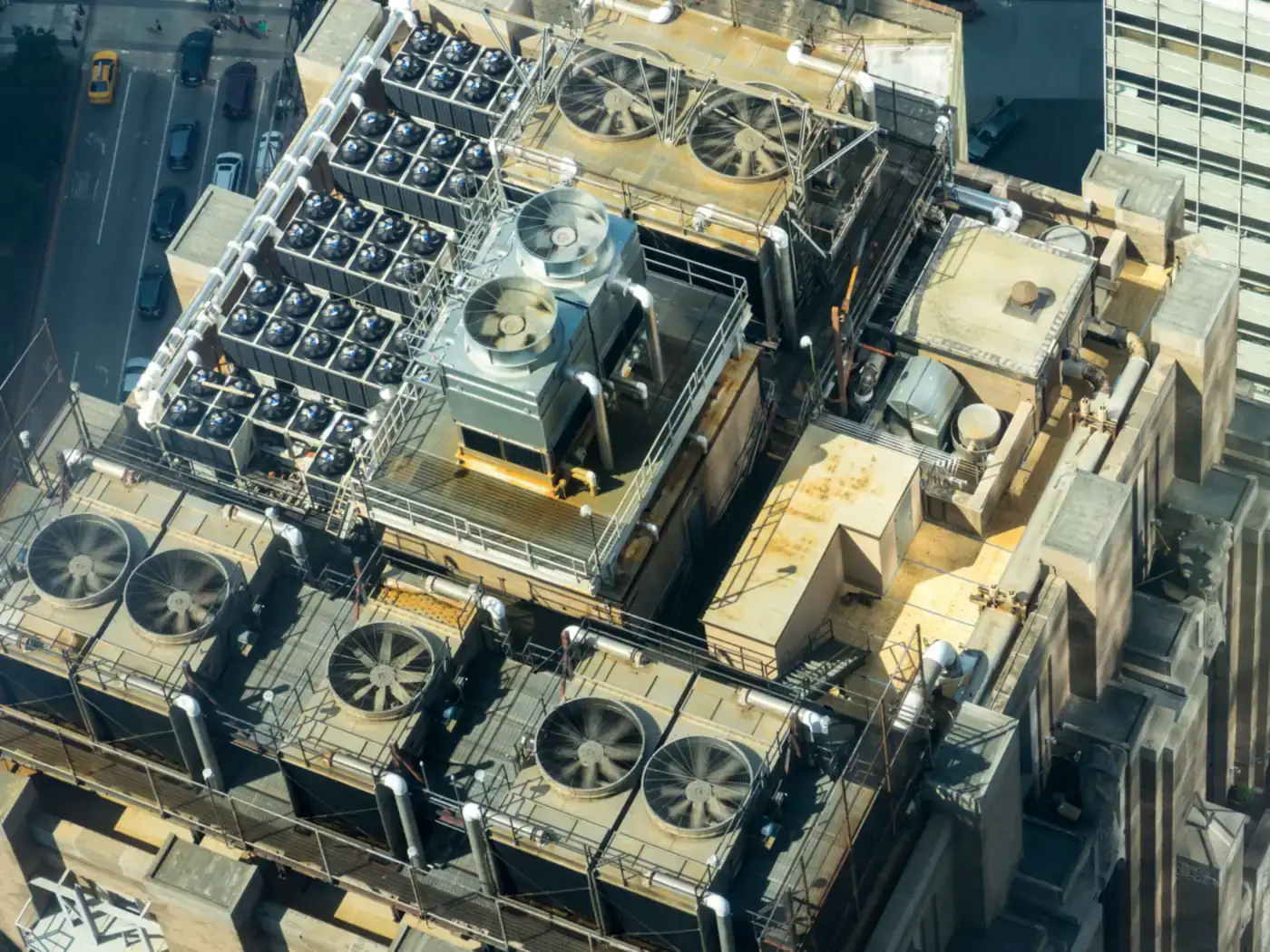 Aerial view of rooftop HVAC units and condenser fans on a commercial building