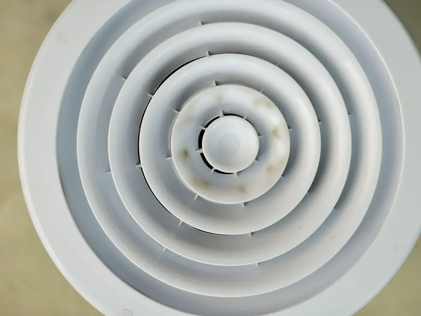 Close-up of a round white ceiling air diffuser